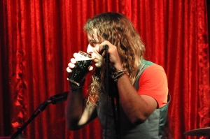 Lead singer, Pat, drinks his band's beer at Cherry Bar