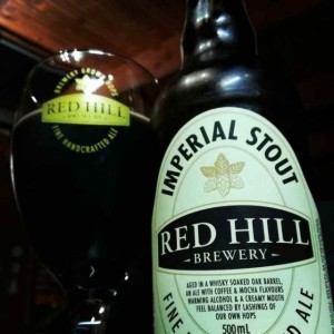 A bottle and glass of Red Hill whisky barrel aged imperial stout